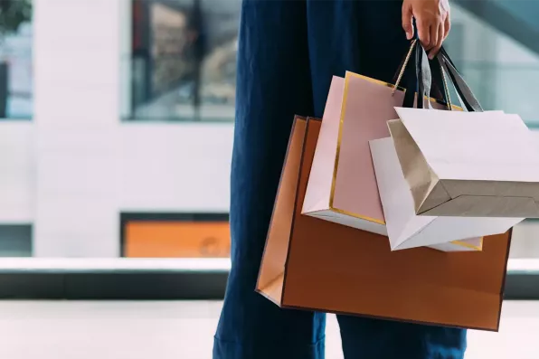 Un homme avec plusieurs sacs dans la main